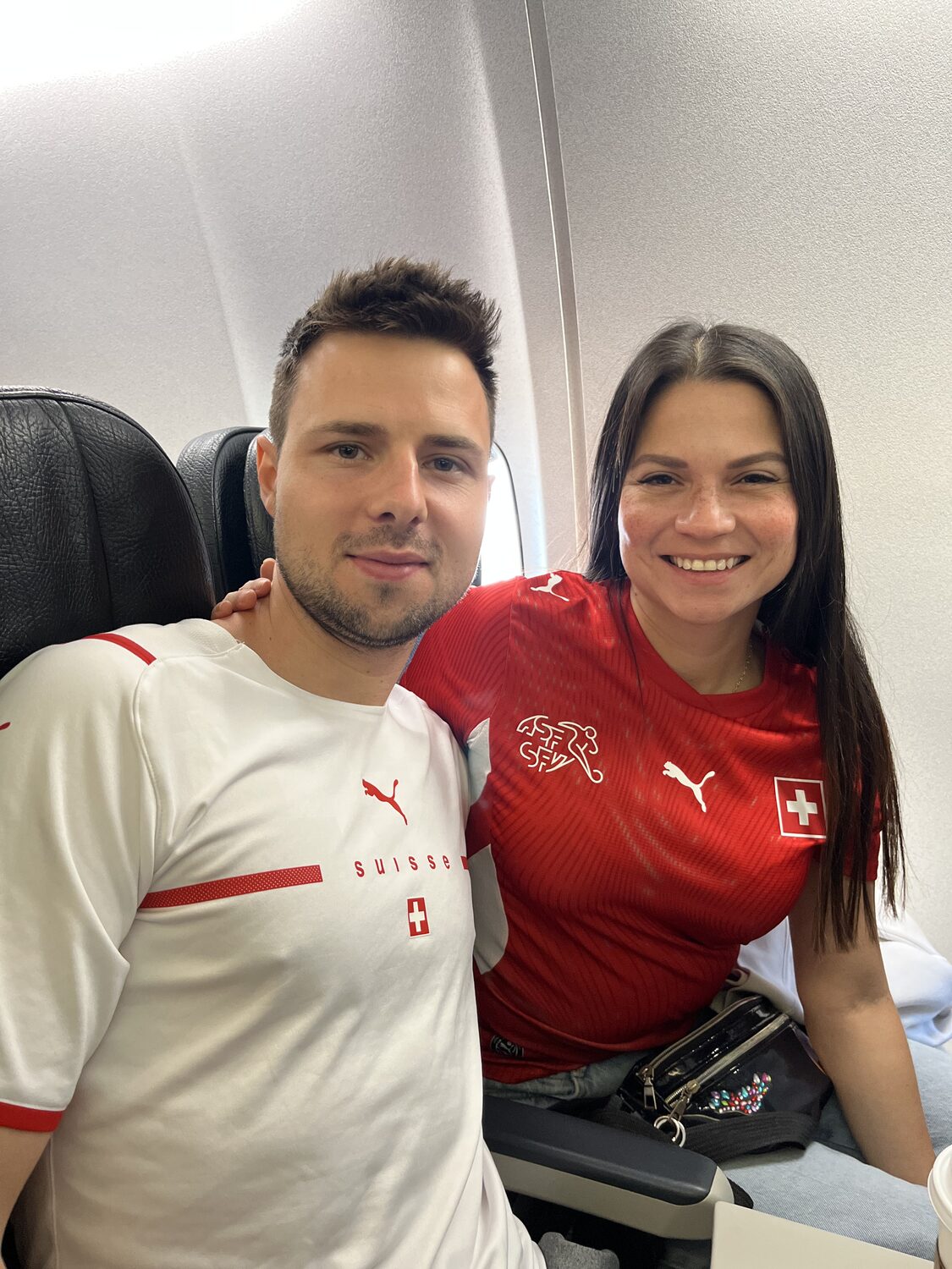 Airplane selfie in Switzerland shirts after leaving Calgary