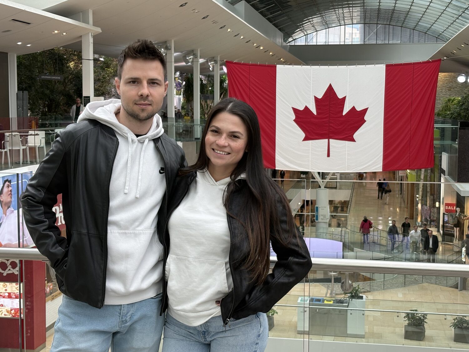 Couple portrait with a Canadian flag in Calgary