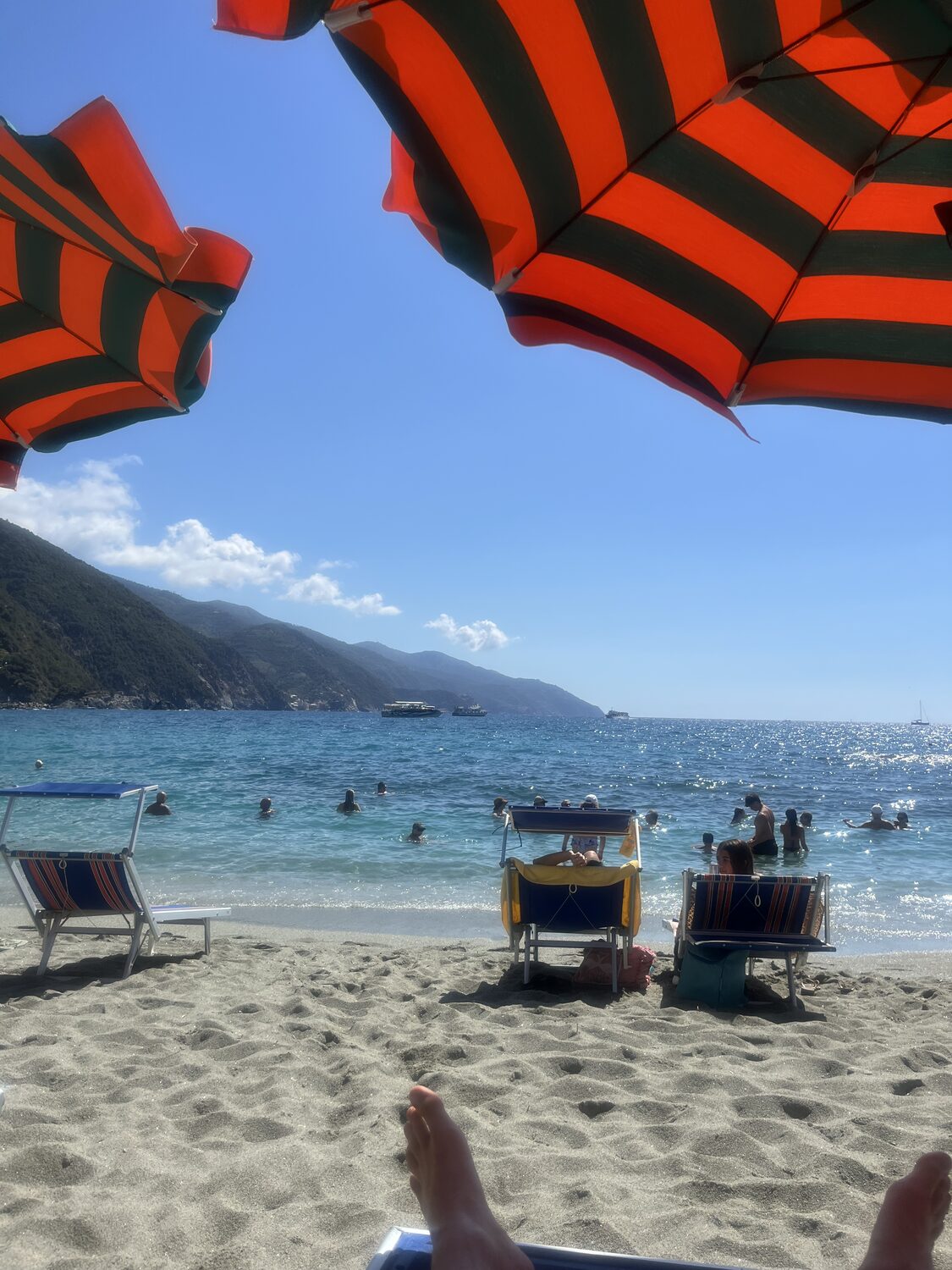 Monterosso beach beneath striped umbrellas