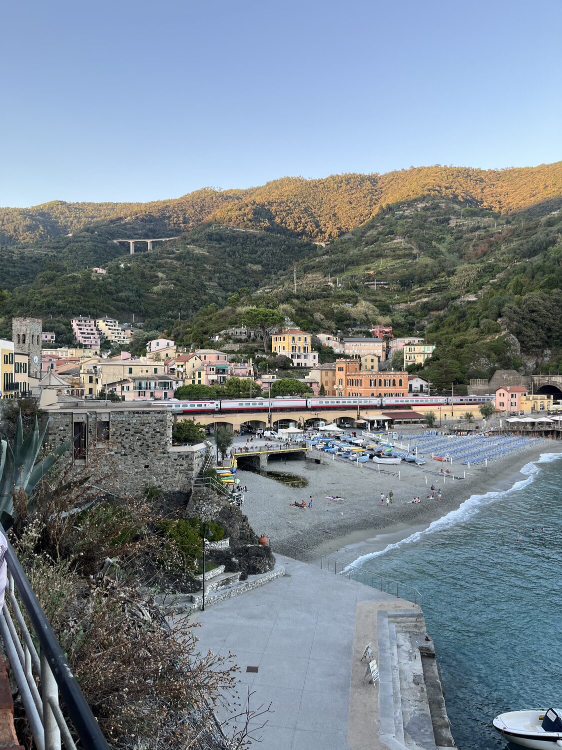 Wide evening view across Monterosso bay