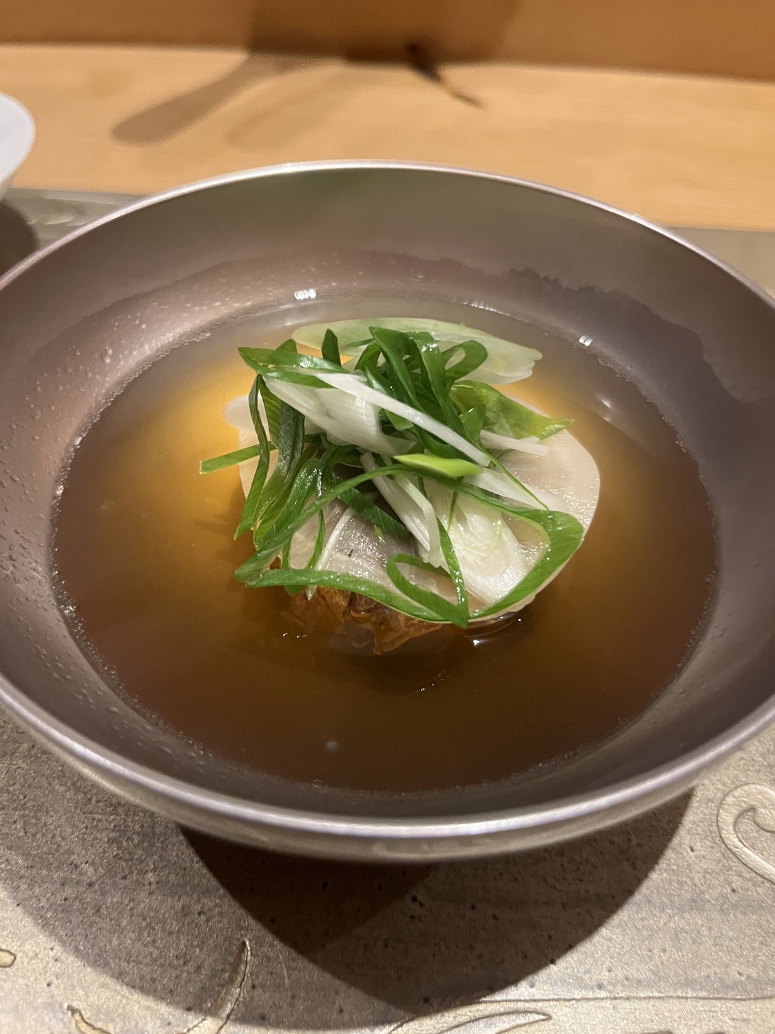 Clear beef consommé with daikon and scallion