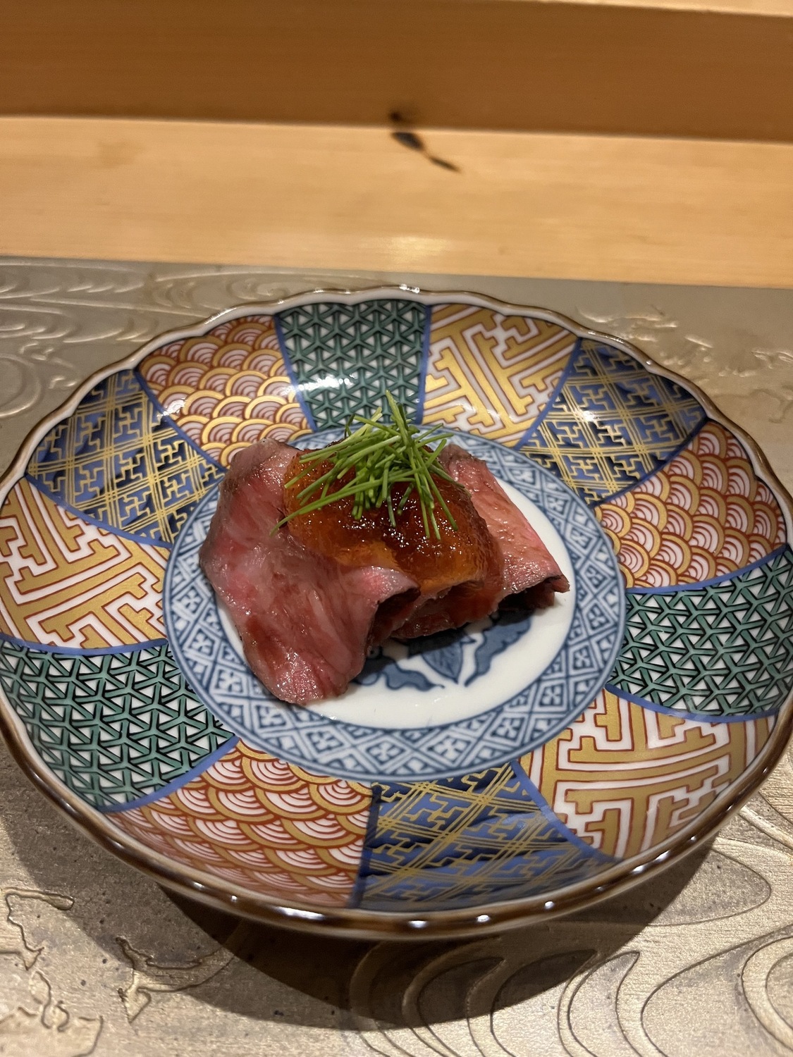Wagyu nigiri on a decorated plate