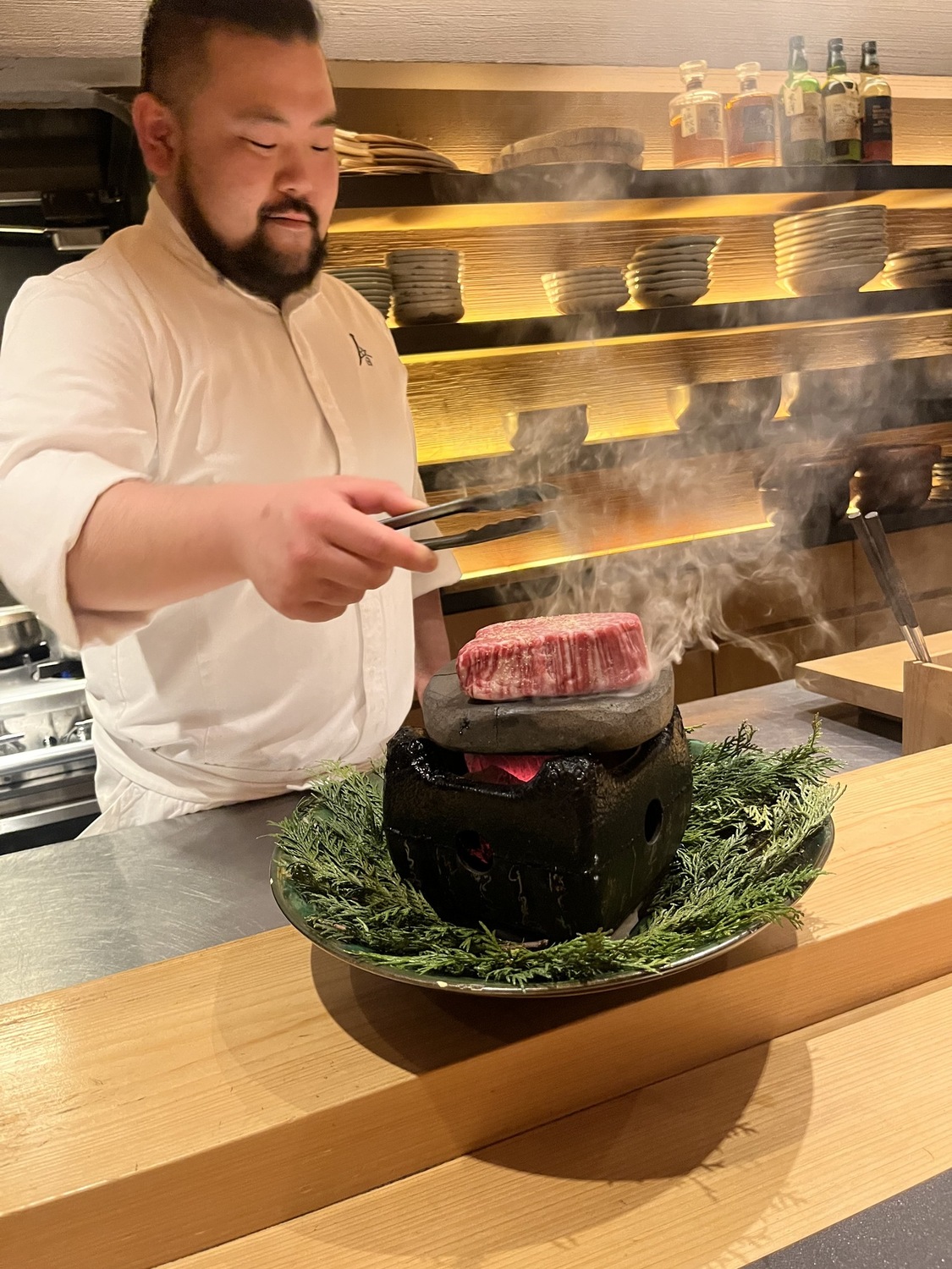 Chef searing wagyu on a hot stone