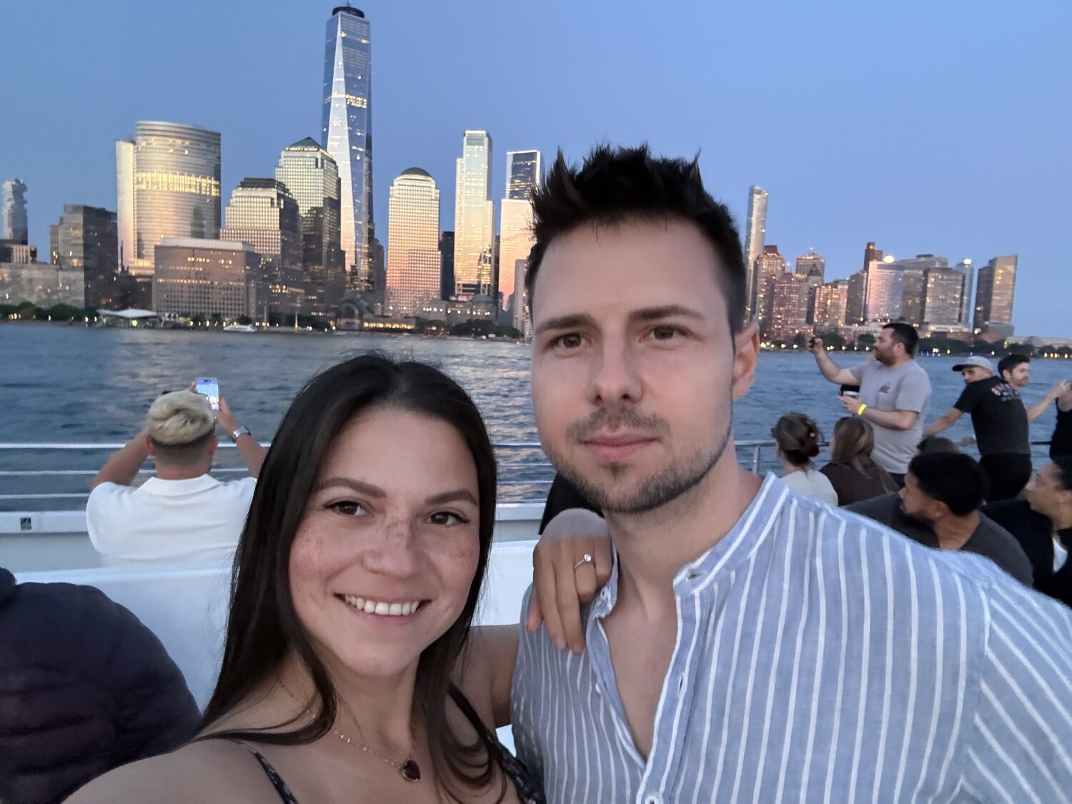 Couple portrait with the Manhattan skyline during the cruise