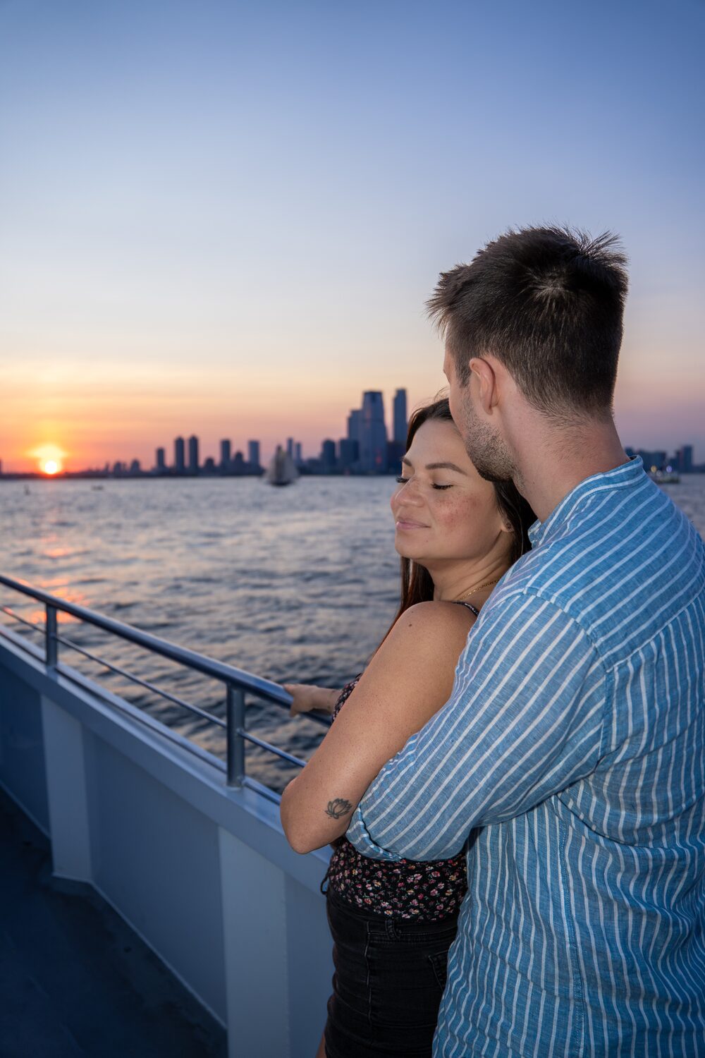 Couple portrait during a New York Harbor sunset cruise